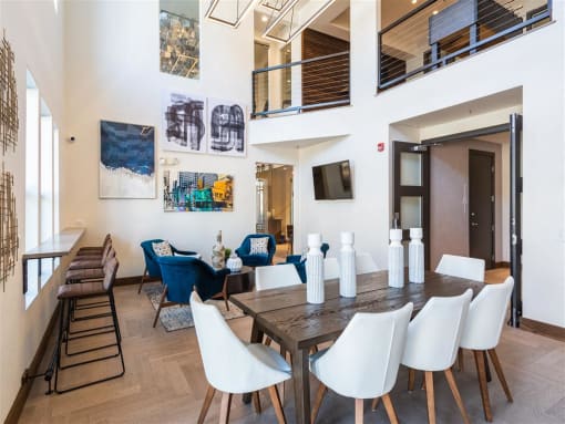 A dining room with a long table and chairs.
