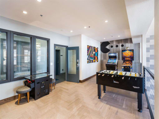 a games room with a foosball table and a video game system
