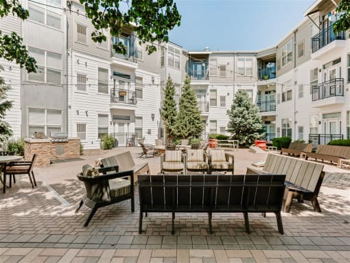 our apartments offer a spacious courtyard with furniture and tables