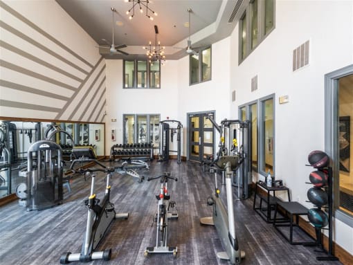 a gym with weights and other exercise equipment in a large room