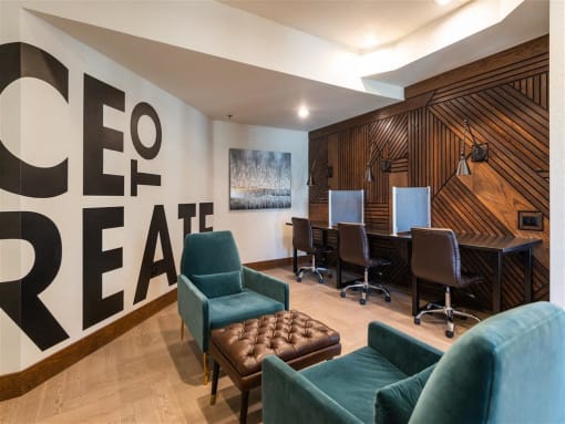 a conference room with a table and chairs and a wall with a sign