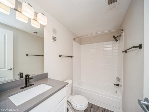Bathroom with a sink and a toilet and a tub  at Avery Park in Englewood, CO