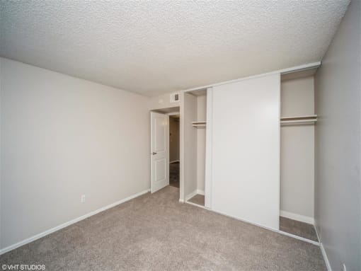 Bedroom with white walls and a closet  at Avery Park in Englewood, CO