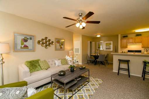A living room with a white couch and a coffee table.