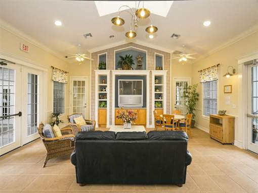 A living room with a black couch and a fireplace.