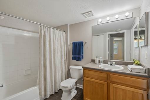 A bathroom with a white toilet, a white sink, and a white bathtub.