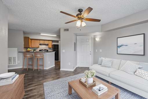 A living room with a white couch and a coffee table.