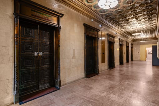 a hallway of elevators and doors in a building