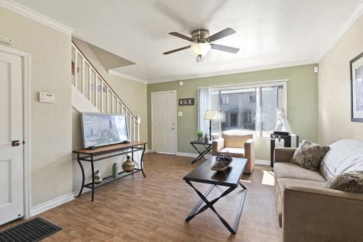 a living room with a couch and a ceiling fan
