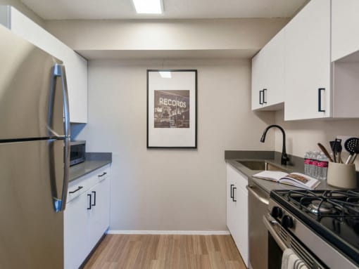 Galley style kitchen with chic white cabinets