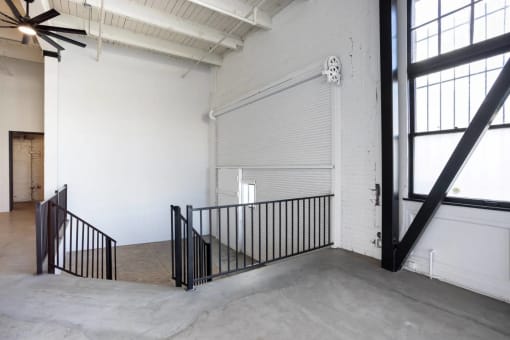 the stairway in the lobby of a building with a garage door