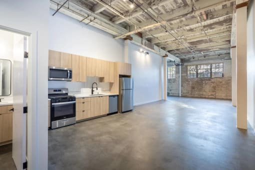 an empty kitchen and living room in a loft