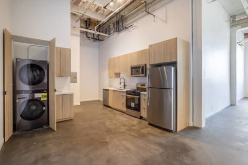 a kitchen with a washing machine and a refrigerator