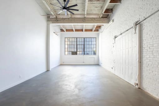 an empty room with white walls and a white door