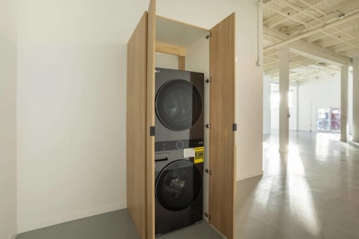 a washing machine in a doorway in a white room