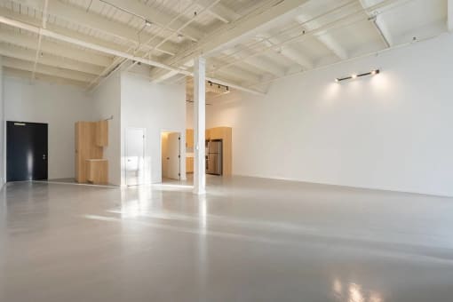 a large room with white walls and wood furniture