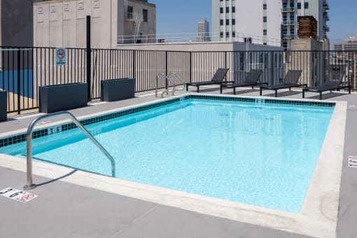 a view of a swimming pool with a city in the background