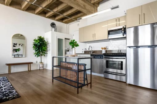 a kitchen with stainless steel appliances and a table