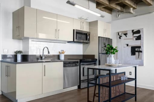 a kitchen with white cabinets and a table with chairs
