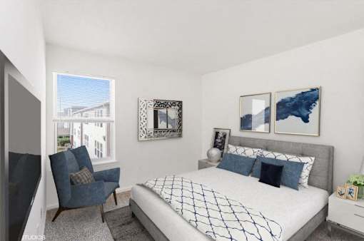 A bedroom with a large bed and a blue chair.