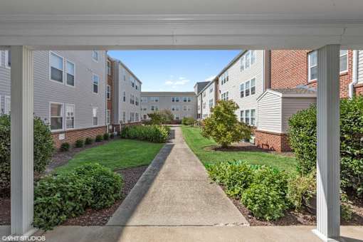 A view of a residential area with apartment buildings and a pathway.