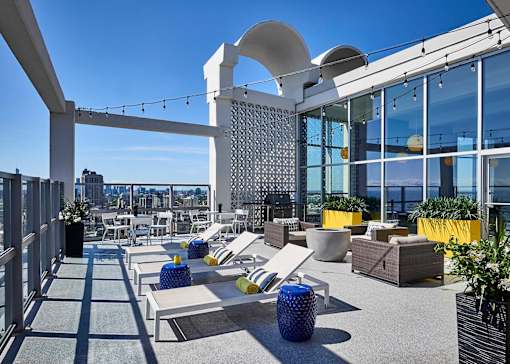 Rooftop sun deck with fire pit and grilling station