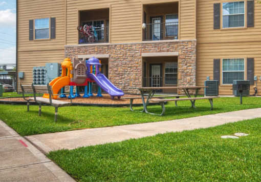 A playground with a slide at Stonehaven Apartments in Houston, TX