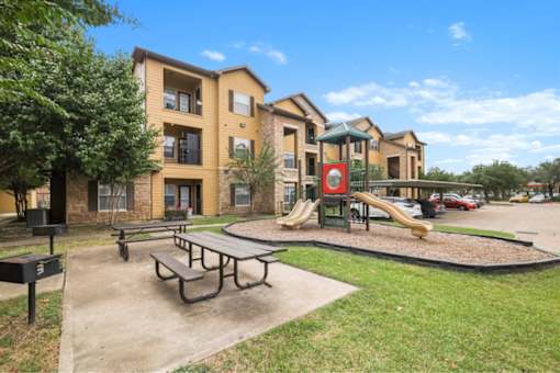 Playground with picnic area and grills at Stonehaven Apartments in Houston, TX