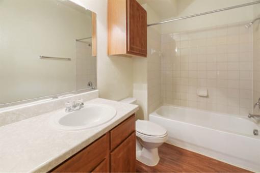Spacious bathroom with tiled bath and large vanity Stonehaven Apartments in Houston, TX