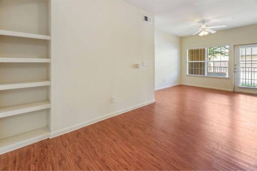 Large open living area with plenty of natural lighting and beautiful flooring at Stonehaven Apartments in Houston, TX