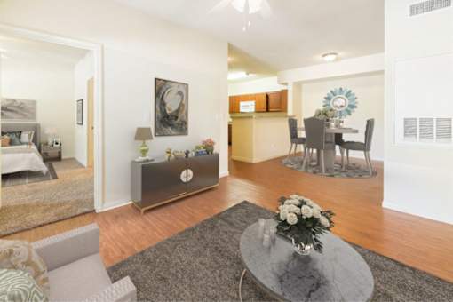 Spacious living room with wood-like plank flooring  at Stonehaven Apartments in Houston, TX