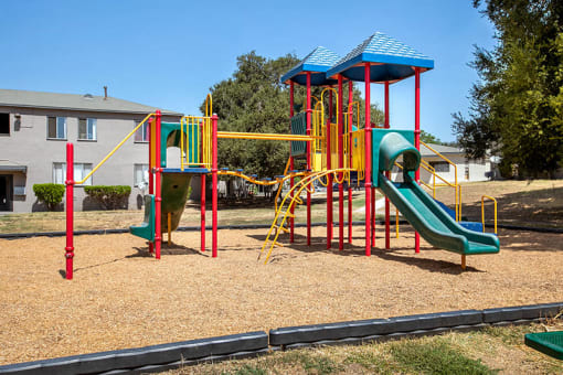 a playground with a swing set and slides
