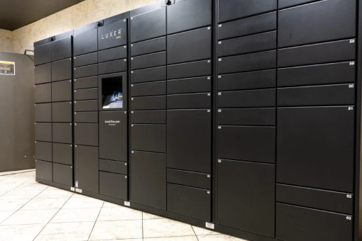 a row of black lockers in a building with a window