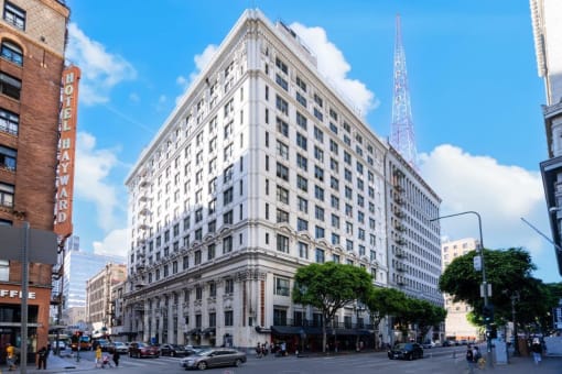 a large white building on the corner of a city street