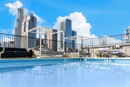 a swimming pool with a city skyline in the background
