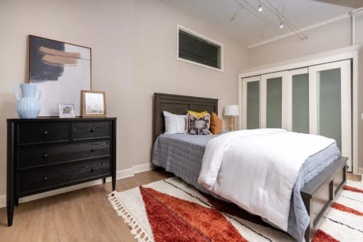 a bedroom with a bed and a dresser