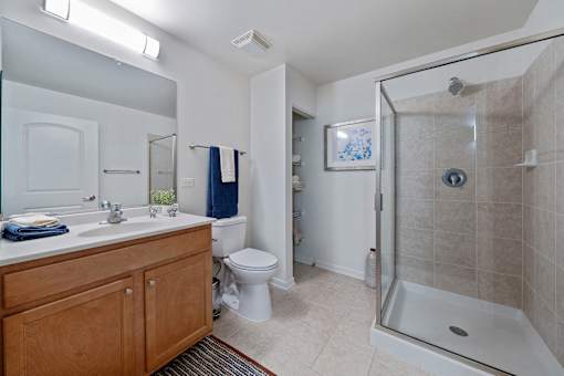 A bathroom with a toilet, sink, and shower.