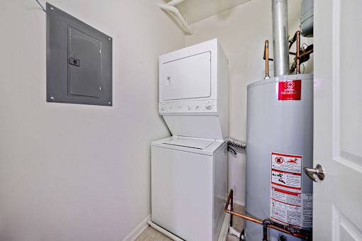 A white washing machine and dryer in a small room.