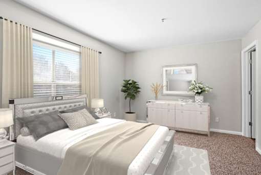 Bedroom with large window and plush carpeting at The Crossings at Russett in Laurel, MD