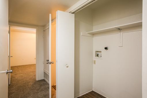 Laundry closet with washer and dryer hookups