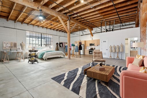 A room with a wooden ceiling and a rug on the floor.