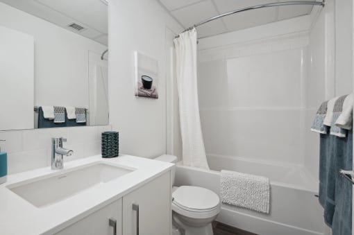 a small bathroom with a sink toilet and shower