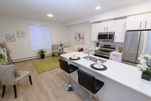 Open-concept living and kitchen area in a Douglas Place apartment in Calgary