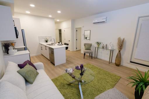 Open-concept living room and kitchen in a Douglas Place apartment