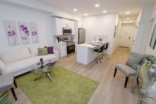 Douglas Place open-concept suite with kitchen island and modern finishes
