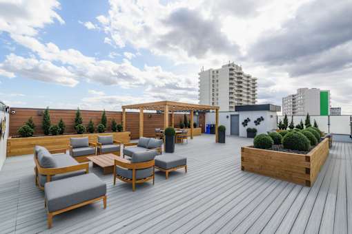 A wooden deck with chairs and a table.