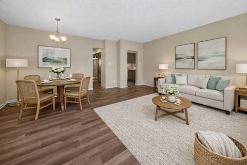 A living room with a dining table and chairs.