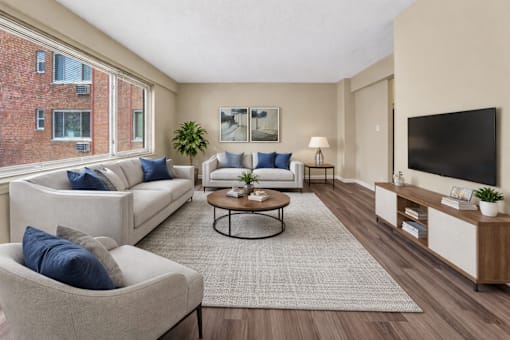 A living room with a couch, chair, and a coffee table.