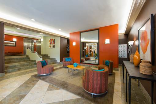 A living room with a brown and orange color scheme.