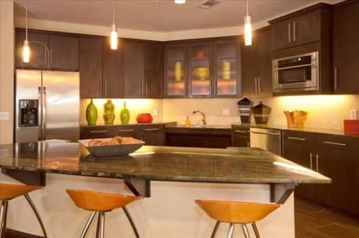 a large kitchen with an island and stainless steel appliances